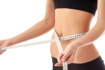 woman measure her waist belly by metre-stick