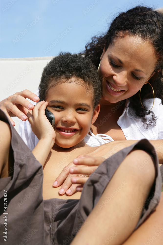 Poster mother and son sat outside with mobile