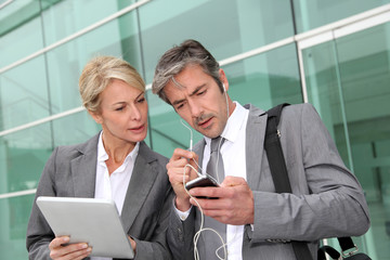 Business team meeting outside with tablet