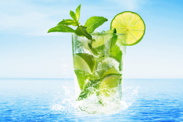Glass of Mojito cocktail  at the beach