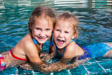 two little girls playing in the pool