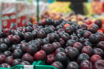 Variety of nectarines in boxes in supermarket