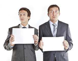 Business couple holding blank signs .