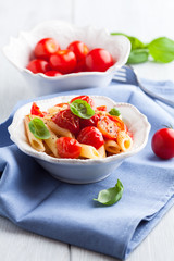 Penne pasta with cherry tomatoes and basil