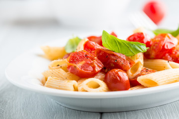 Penne pasta with cherry tomatoes and basil
