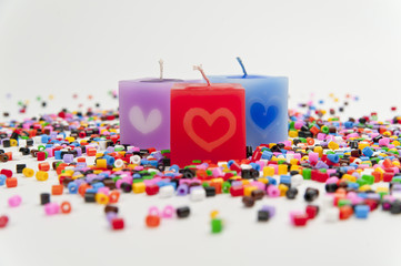 Three color candle on tiny colorful plastic tube