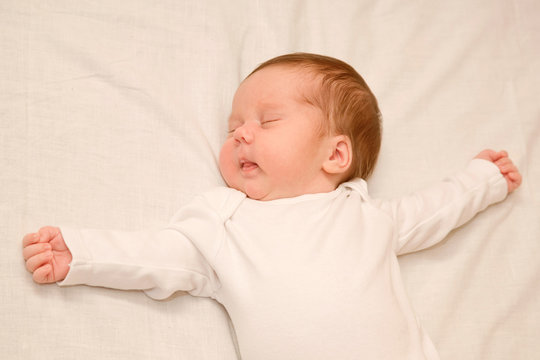 Newborn Baby Sleeping  Arms Spread Out