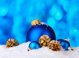 beautiful blue Christmas balls and cones in snow