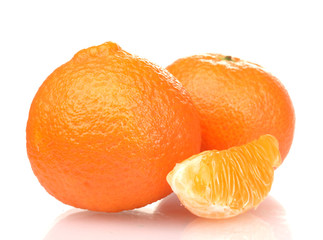 Ripe tasty tangerines and segments isolated on white