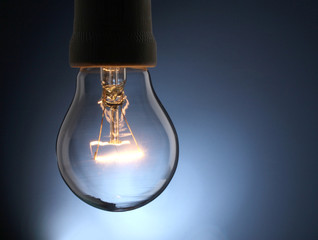 A lit light bulb isolated on white