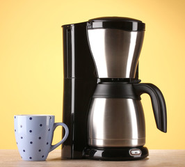Coffee maker on yellow background