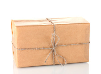 Parcel wrapped in brown paper tied with twine isolated on white