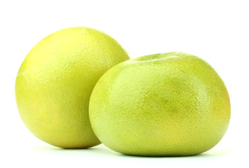 two green grapefruits isolated on white