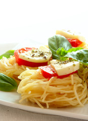Italian pasta with tomatoes and cheese close up
