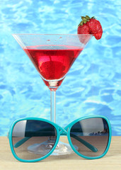 Beach composition of fashionable women's sunglasses and a