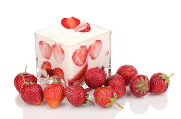 Glass of ripe strawberries with cream isolated on white