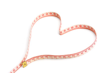 A measuring tape shaping a heart isolated on white background