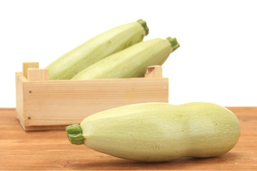 squash in a box on wooden table on white background close-up