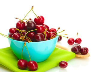 Ripe cherry berries in bowl isolated on white