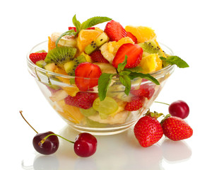 glass bowl with fresh fruits salad and berries isolated on