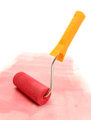 Paint roller with red paint isolated on white
