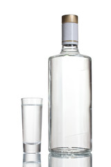 Bottle of vodka and wineglass isolated on white