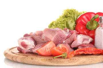 Pieces of raw meat and vegetables