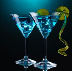 Blue cocktail in martini glasses on blue background