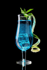 Blue cocktail in glasses on black background