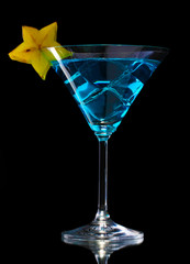 Blue cocktail in glass on black background