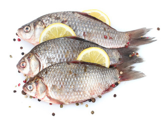 Fresh fishes with lemon and spice isolated on white