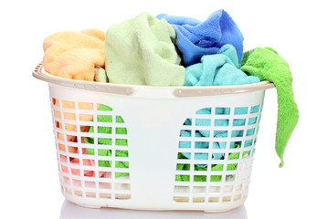 Plastic basket with bright towels isolated on white