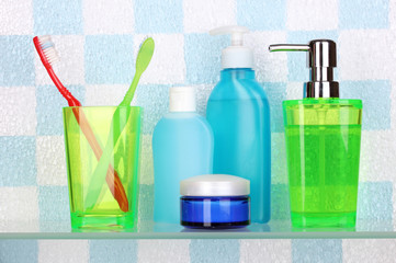 Shelf with cosmetics and toiletries in bathroom