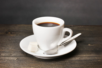 Coffee cup on wooden table on grey background
