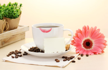 cup of coffee with lipstick mark and gerbera beans, cinnamon