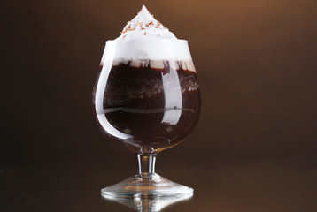 glass of coffee cocktail on brown background