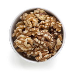 Walnuts in White Bowl over White Overhead View