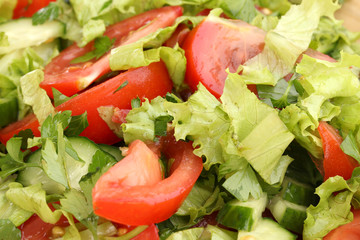 Fresh salad with tomatoes and cucumbers close-up