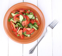 Fresh salad on white wooden background