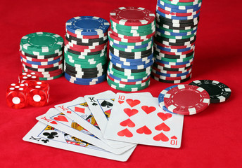 four of a kind with poker chips on a red poker table close-up