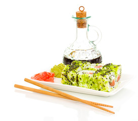 Tasty rolls on plate with chopsticks isolated on white