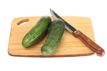 Cucumbers on cutting board isolated on white