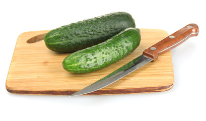 Cucumbers on cutting board isolated on white