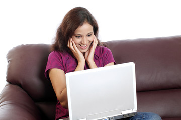 Excited Indian woman working with laptop