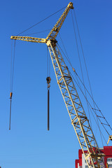 yellow crane and blue sky on building site