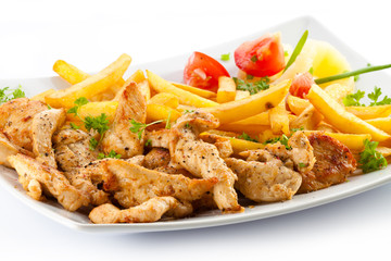 Grilled meat French fries and vegetables on white background