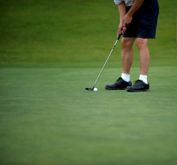 golfer putting on the green