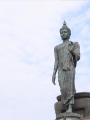 Walking buddha statue