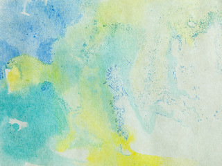 paper with blue green and yellow paint abstract