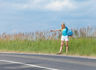 Hitchhiking girl votes on road